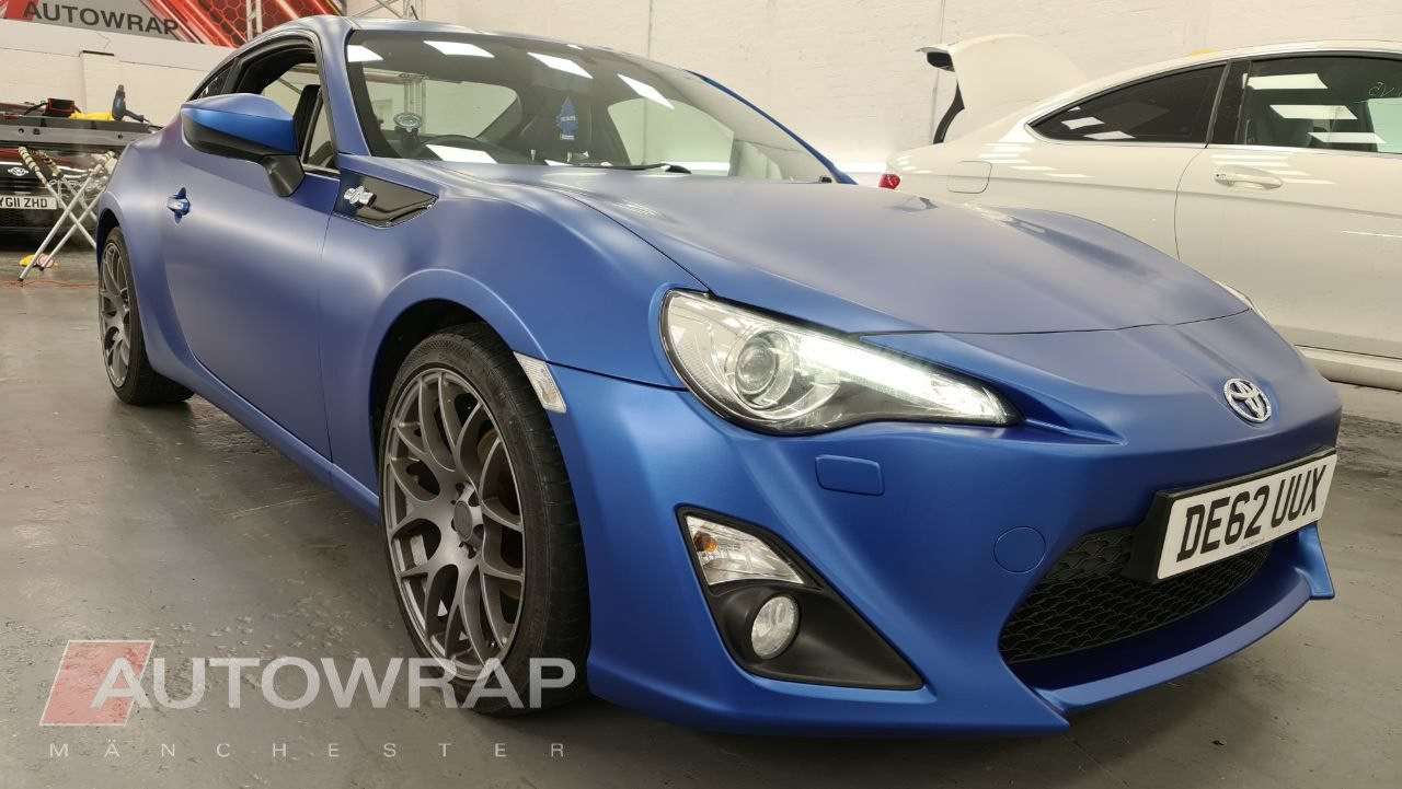 A Toyota GT86 shown on an angle in in an industrial unit. It has just had a